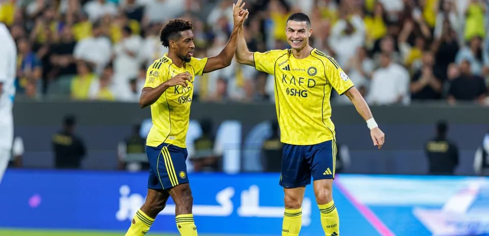 Two players celebrating a goal on the field