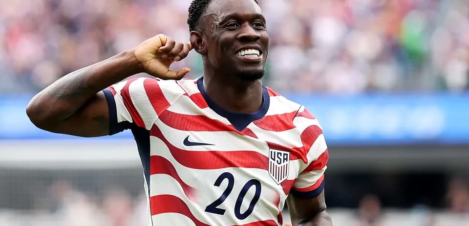 Player celebrating goal in USA jersey during match