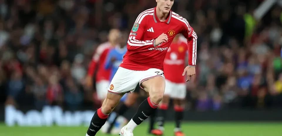 Player running on the field in Manchester United kit