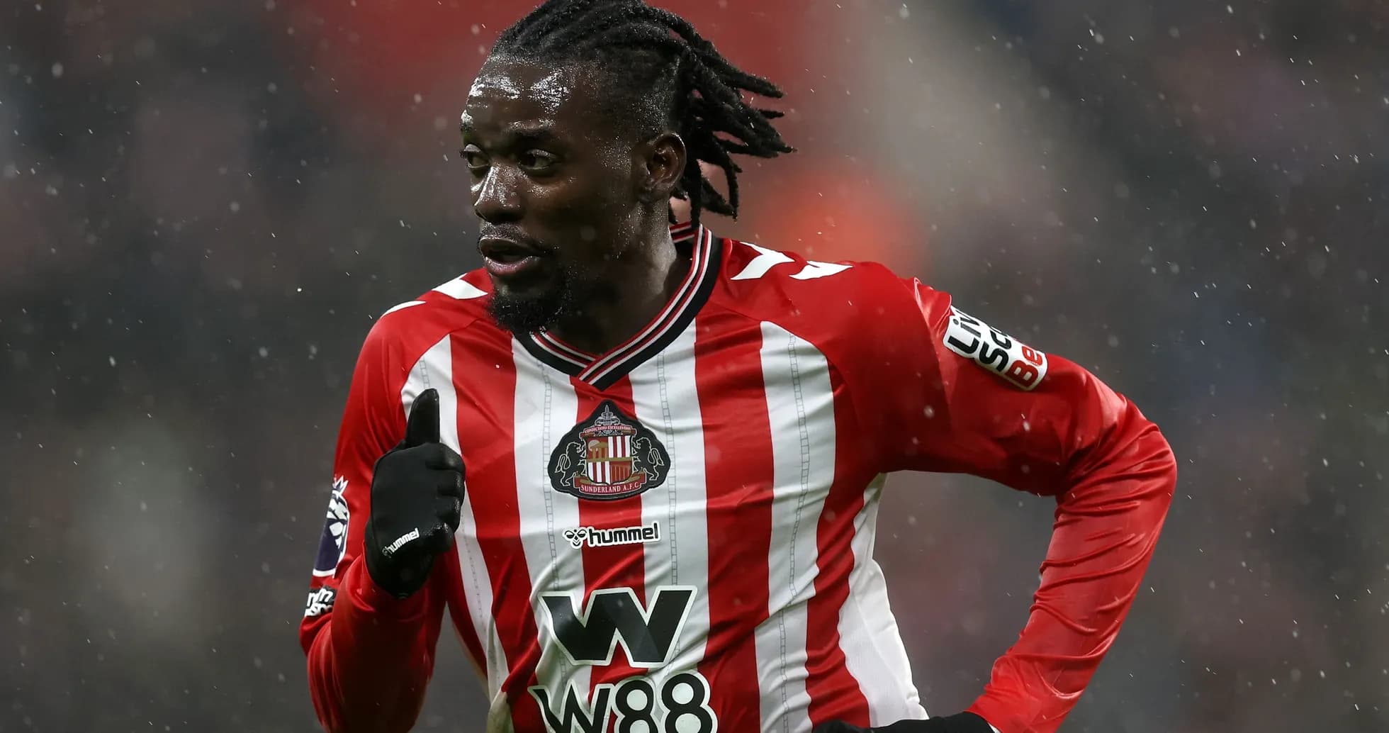 Player running in Sunderland AFC home kit during match