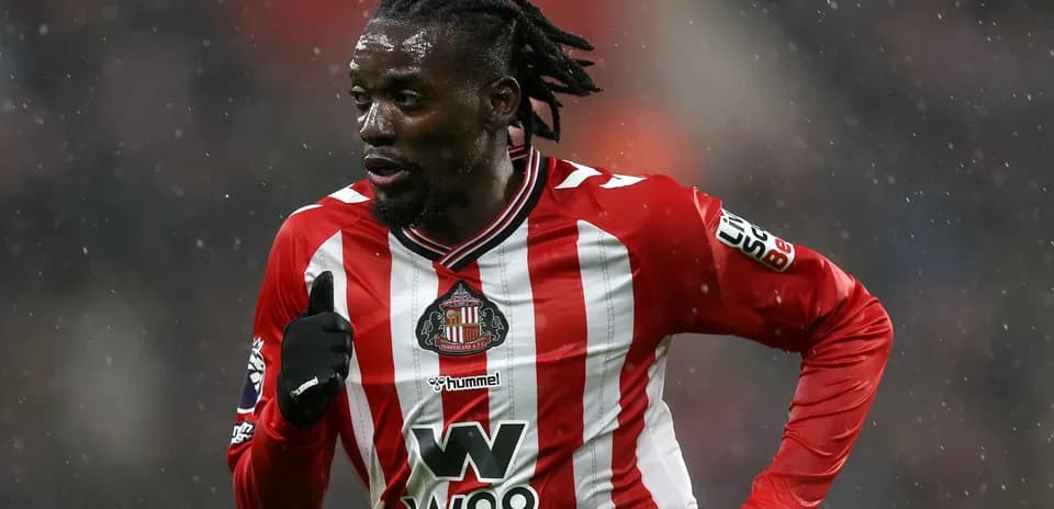 Player running in Sunderland AFC home kit during match