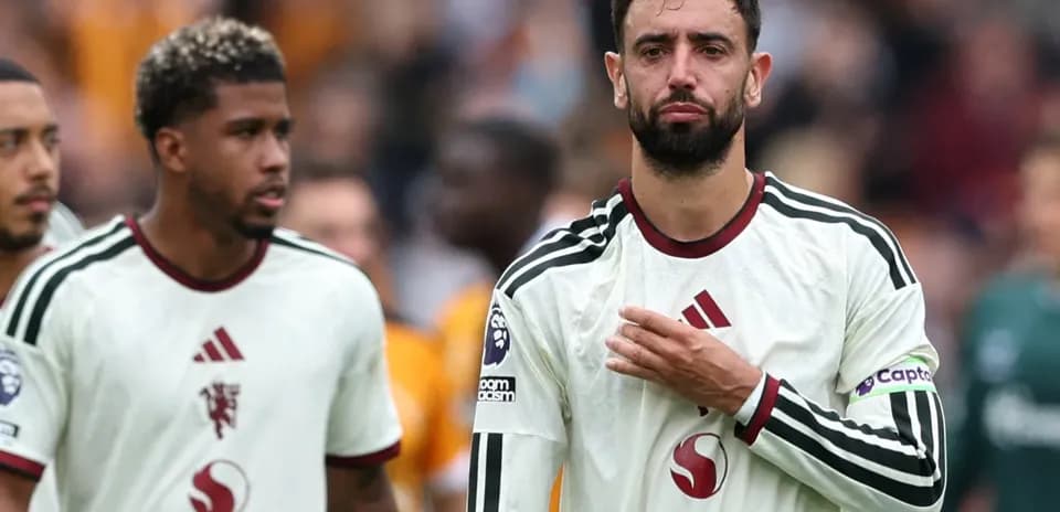 Bruno Fernandes and teammate walking off the pitch