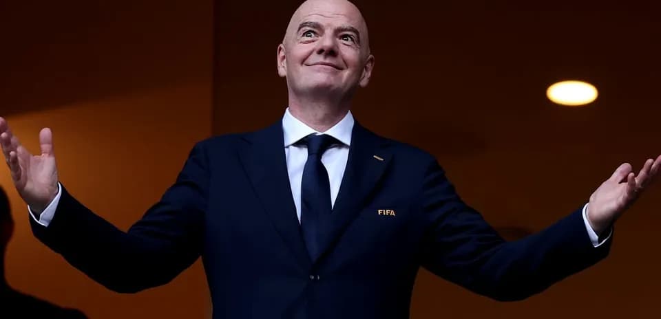 FIFA president gesturing from VIP box during event