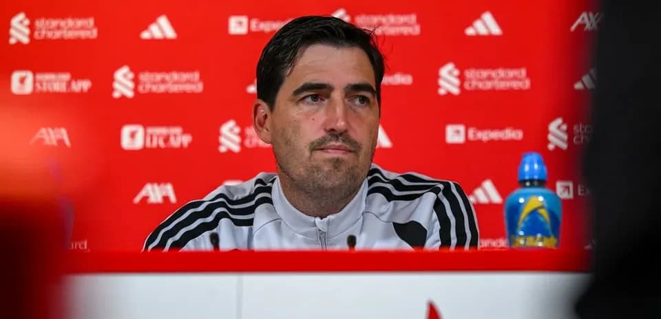 Manager at press conference with sponsor backdrop