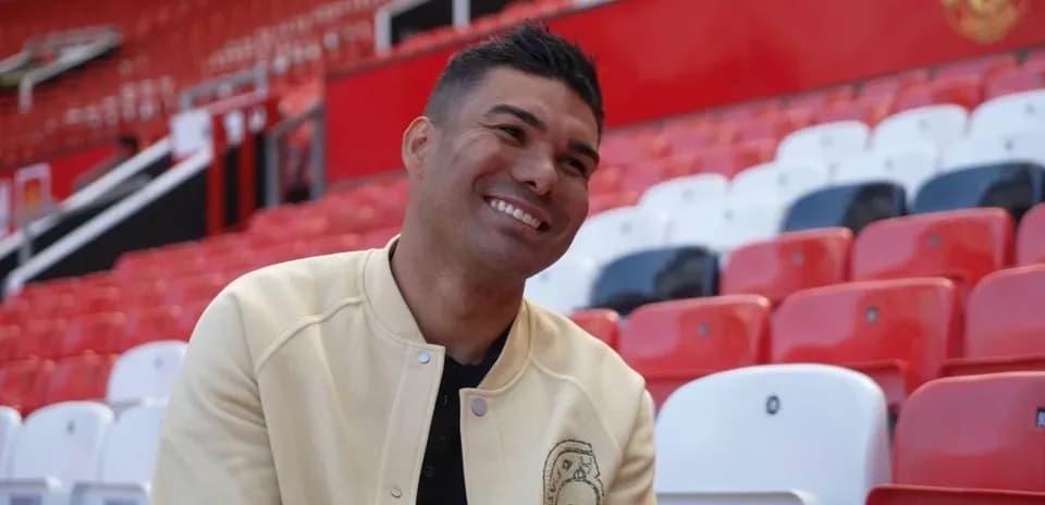 Player seated in stadium with red and white seats