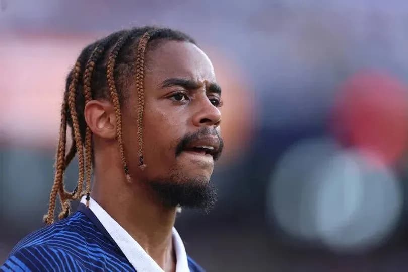 Player with braided hair during match warm-up