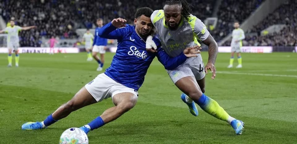 Two players competing for the ball on the field