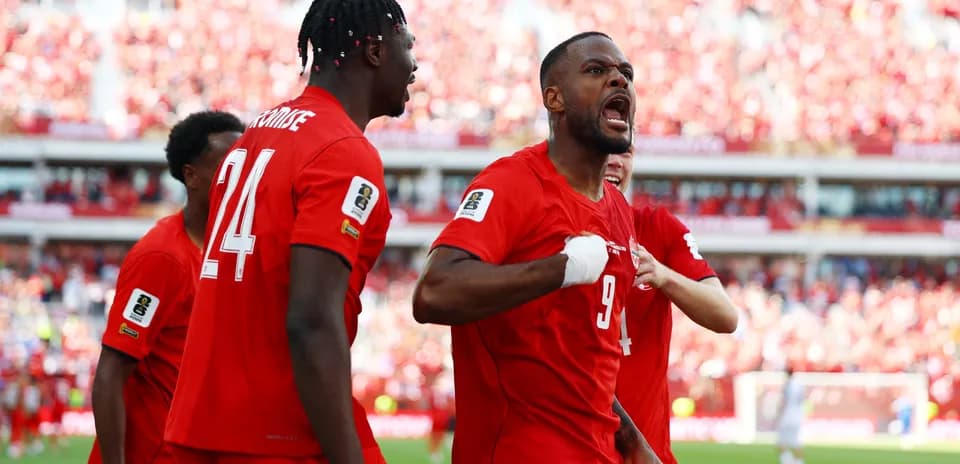 Canada players celebrating a goal in World Cup match