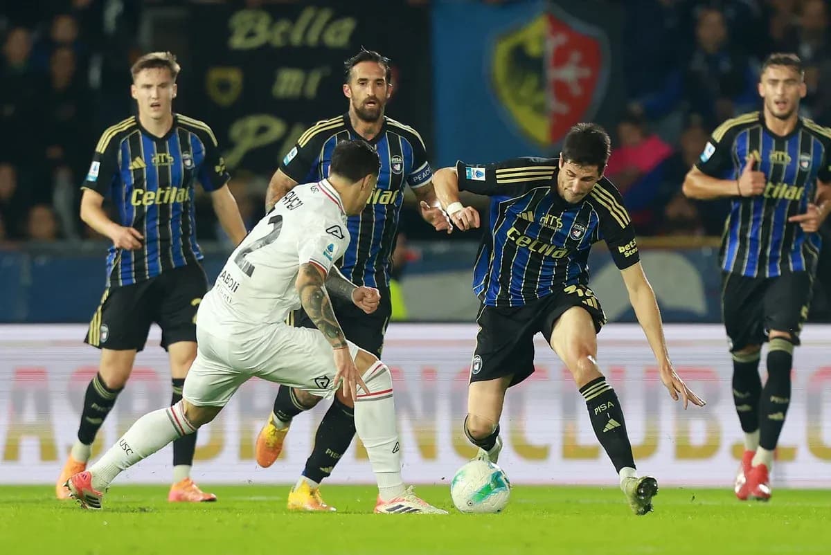 Cremonese players challenging Pisa during match