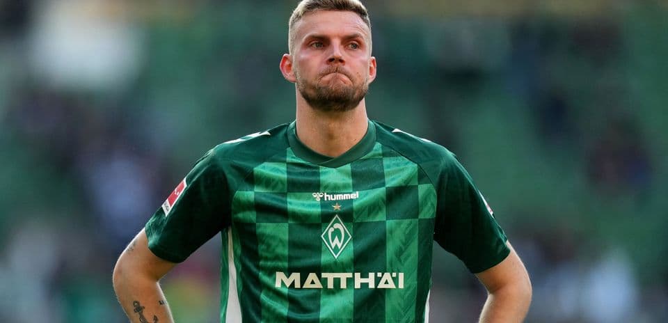 Player in green jersey standing on field