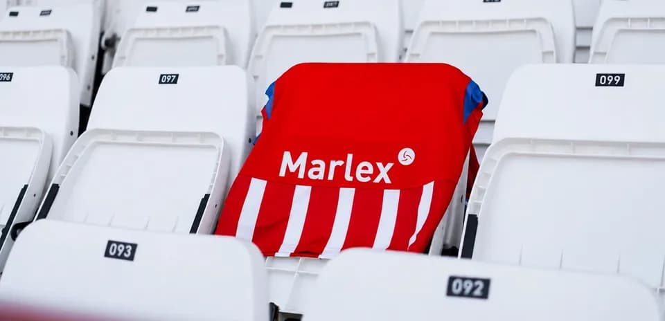 Red and white jersey on empty stadium seat