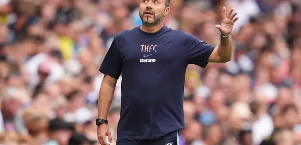 Coach gesturing from the sidelines during match
