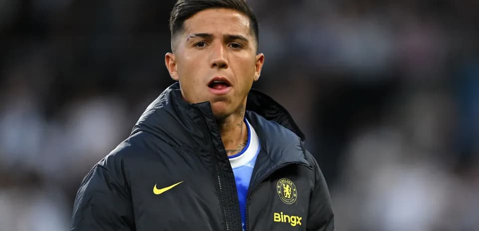 Player in Chelsea jacket during match warm-up