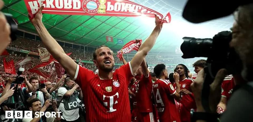 Player celebrating with Bayern Munich fans in stadium
