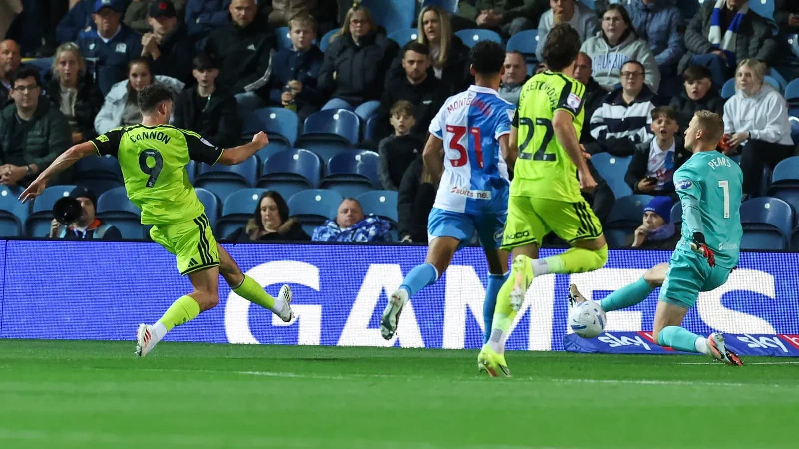 Player shooting at goal while goalkeeper prepares to save