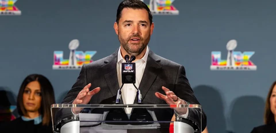 Speaker at NFL press conference addressing audience