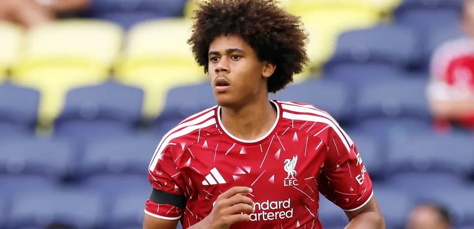 Player warming up on the pitch in Liverpool kit