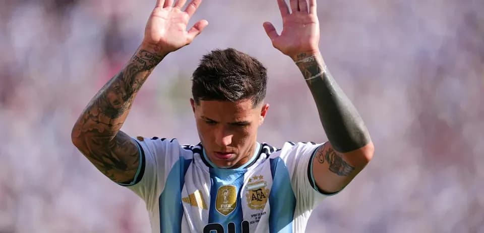 Player raising hands during match wearing Argentina jersey