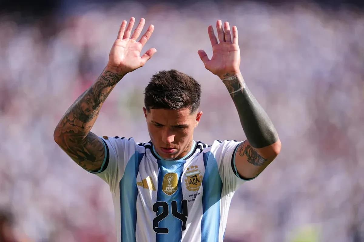 Player raising hands during match wearing Argentina jersey
