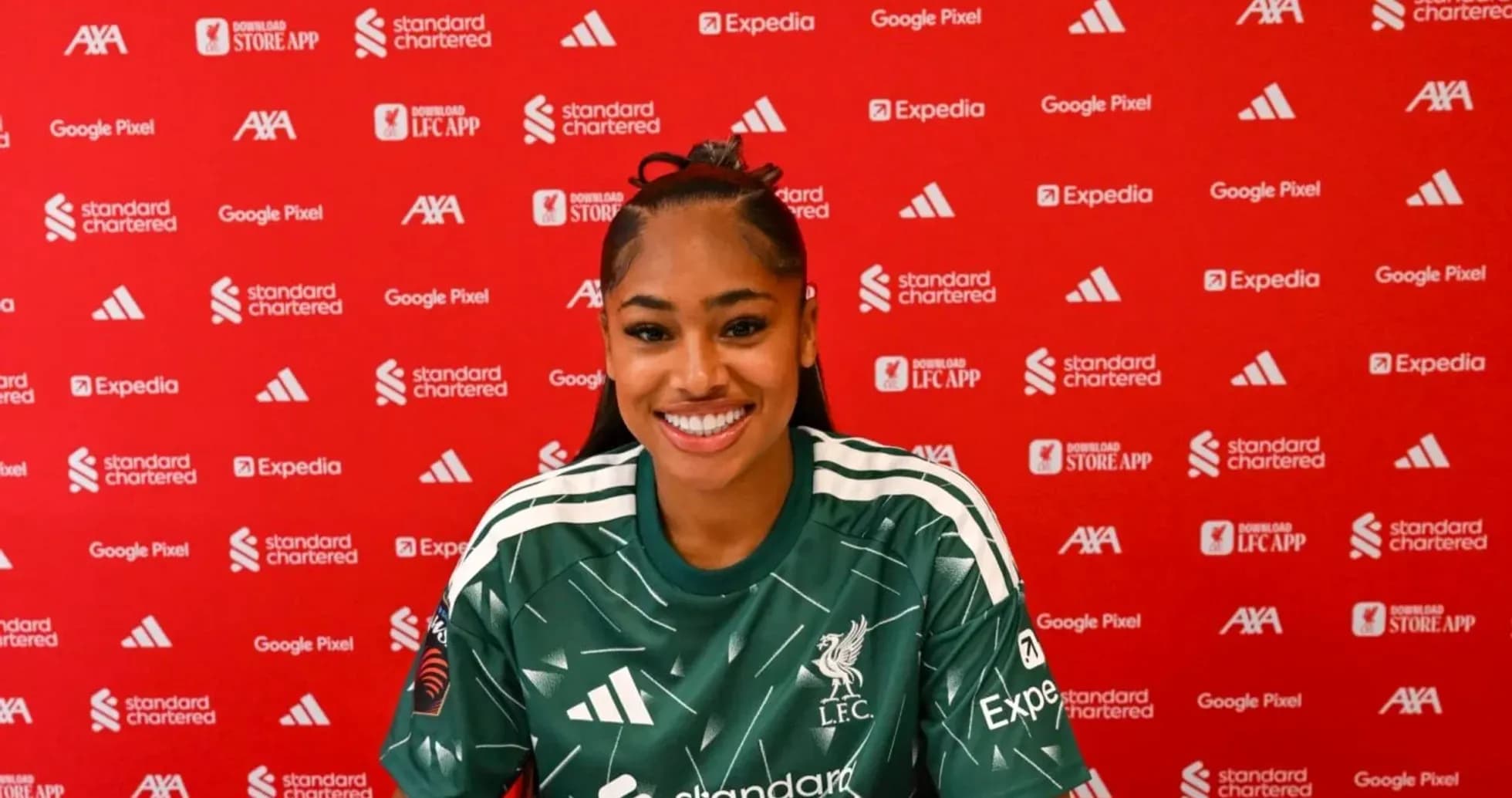 Player smiling during press conference at Liverpool FC