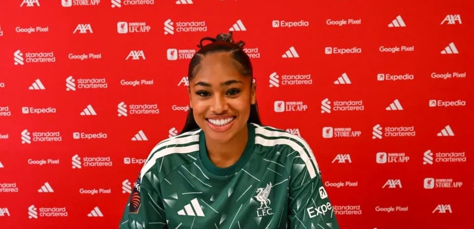 Player smiling during press conference at Liverpool FC