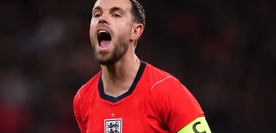 Player celebrating with arms raised in red jersey