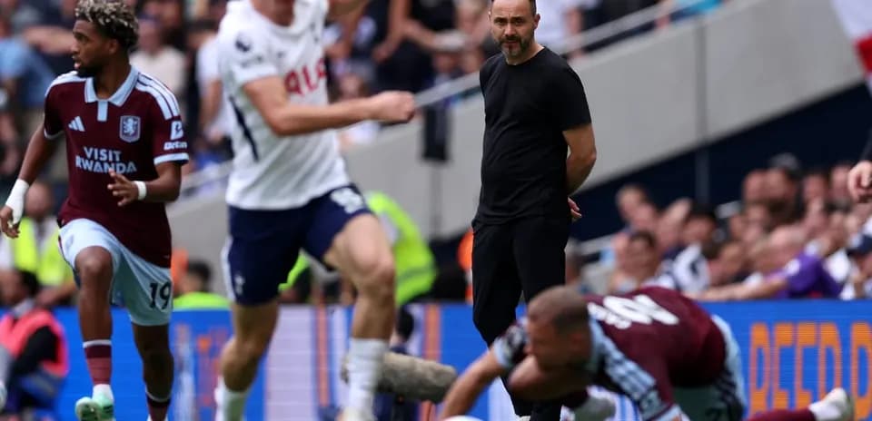 Aston Villa player running past Tottenham's coach