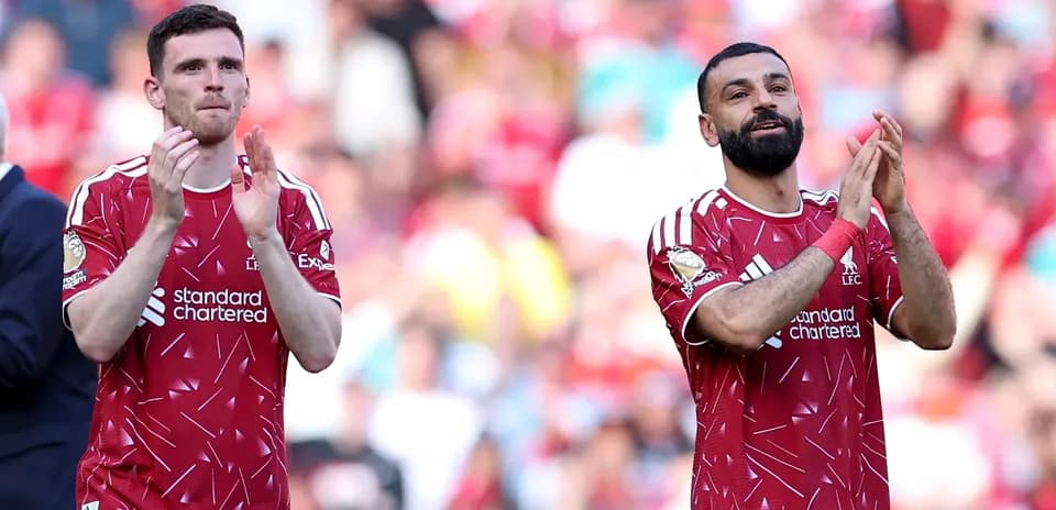 Liverpool players applauding fans after match