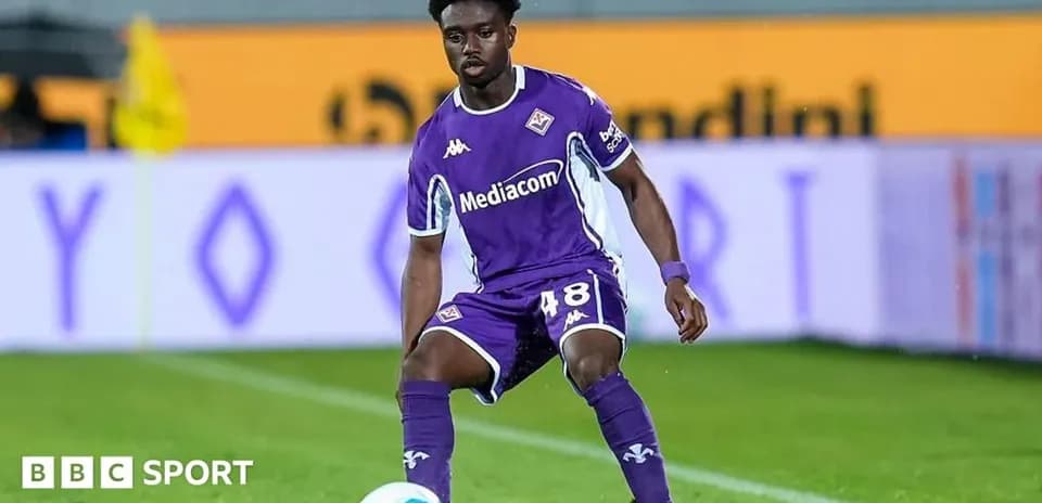 Player in purple uniform preparing to pass ball
