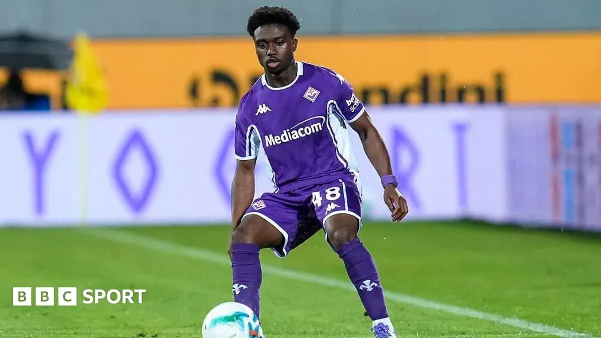 Player in purple uniform preparing to pass ball
