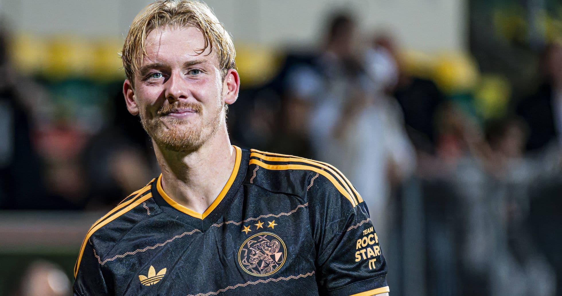 Player smiling in Ajax jersey after match Player smiling in Ajax jersey after match