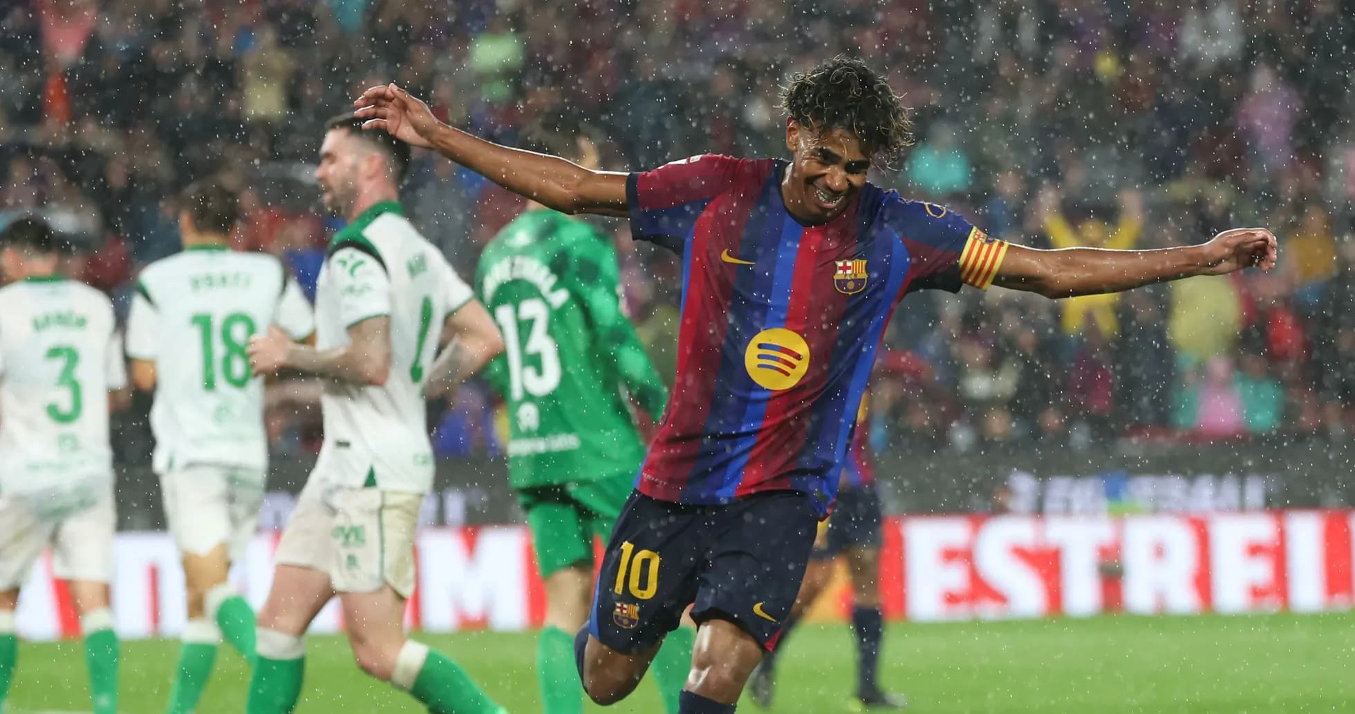 Barcelona player celebrating a goal in the rain Barcelona player celebrating a goal in the rain