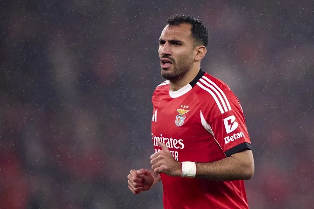 Benfica player running in the rain during match Benfica player running in the rain during match