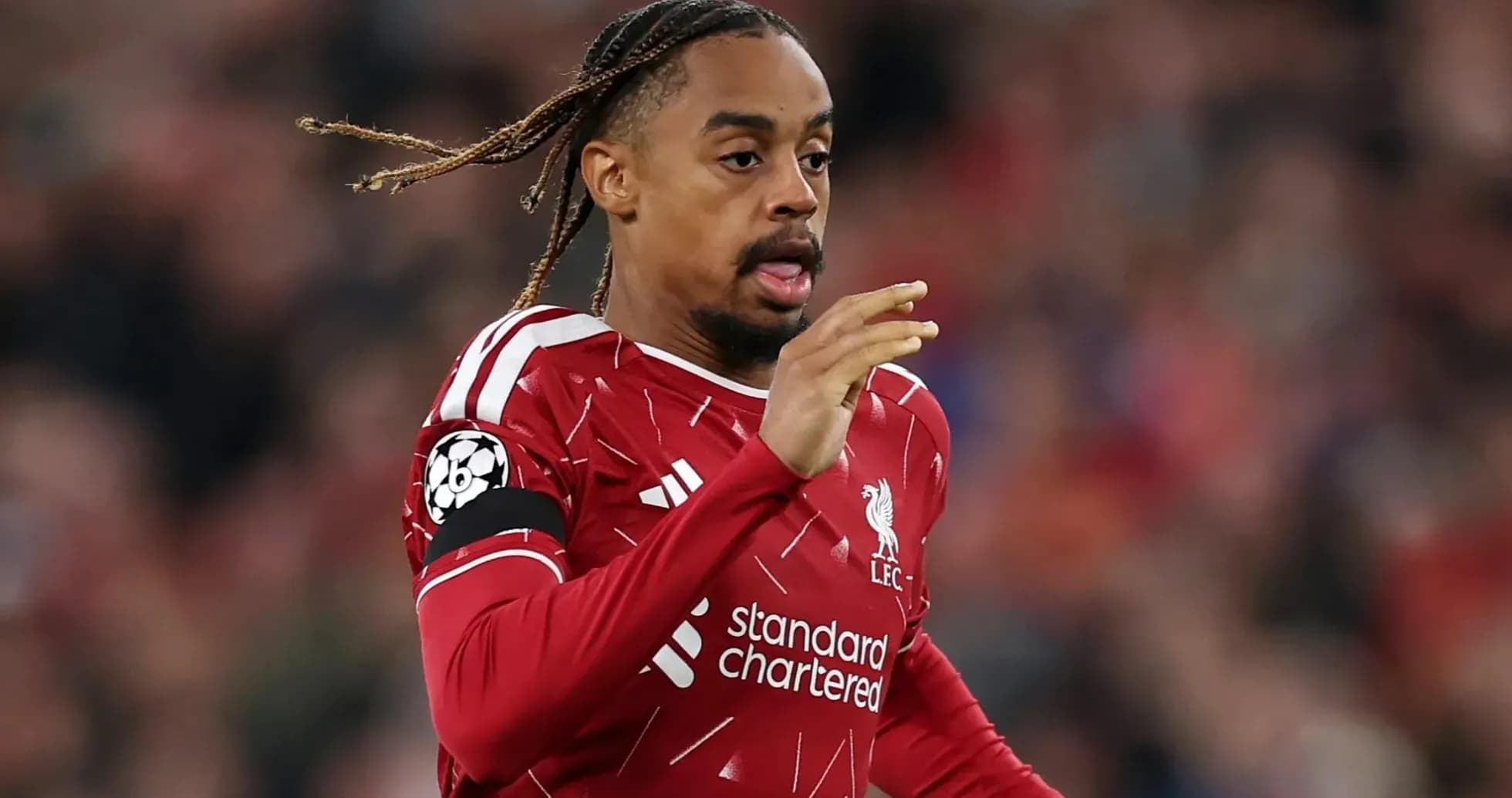 Player in Liverpool kit running on the pitch Player in Liverpool kit running on the pitch
