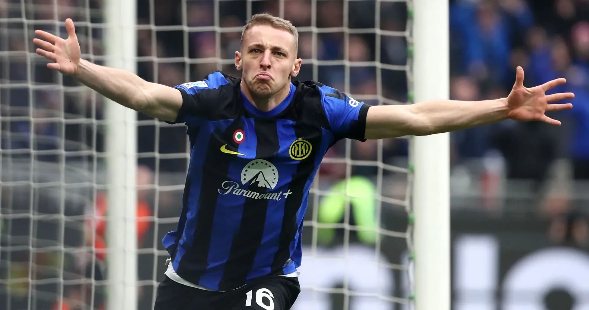 Player celebrating a goal in blue and black uniform Player celebrating a goal in blue and black uniform