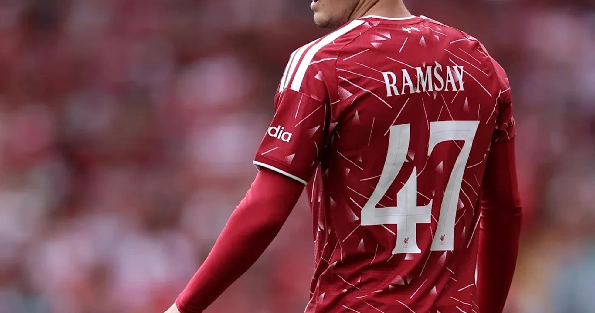 Player in red jersey with number 47 on field Player in red jersey with number 47 on field