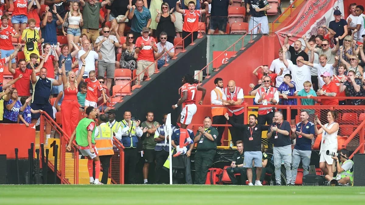 Fans celebrating a goal in the stadium stands Fans celebrating a goal in the stadium stands