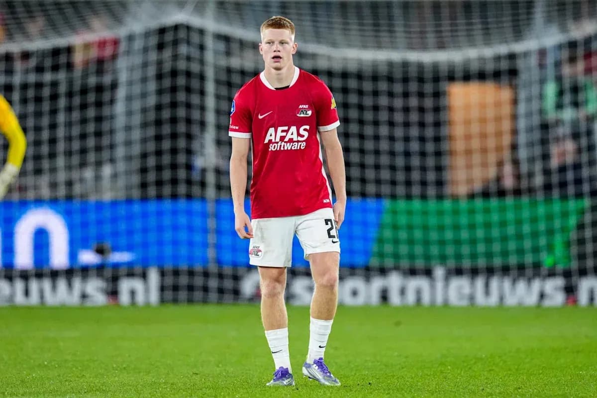 Player in red jersey standing on the pitch Player in red jersey standing on the pitch