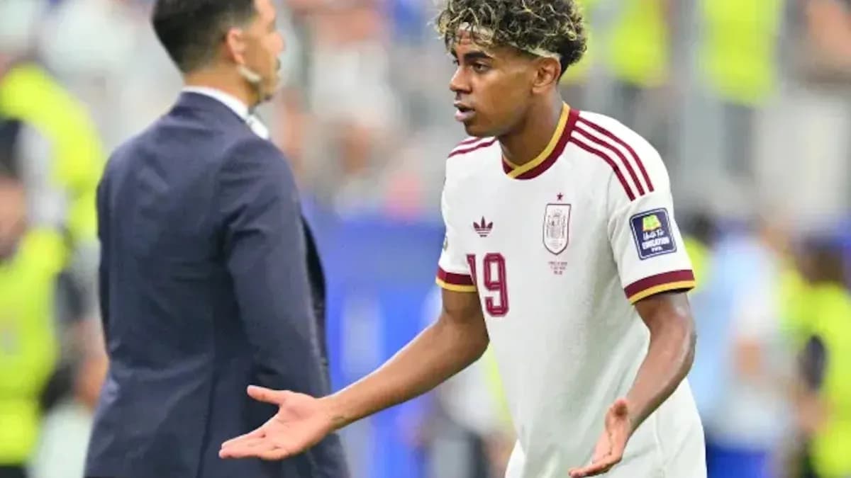 Player gesturing during match with coach nearby Player gesturing during match with coach nearby