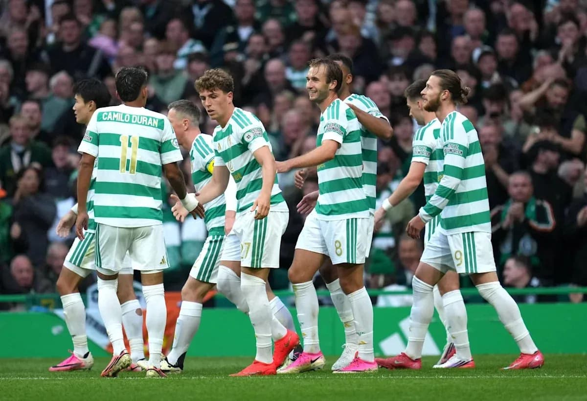 Celtic players celebrating a goal on the field Celtic players celebrating a goal on the field