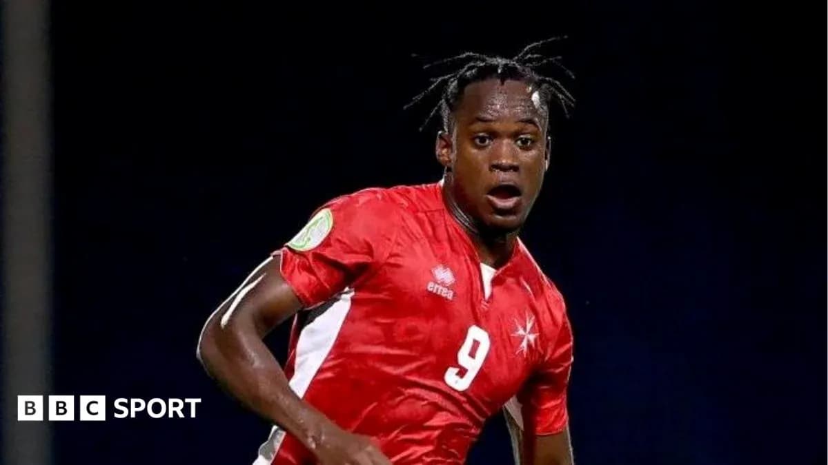 Player in red jersey during football match Player in red jersey during football match
