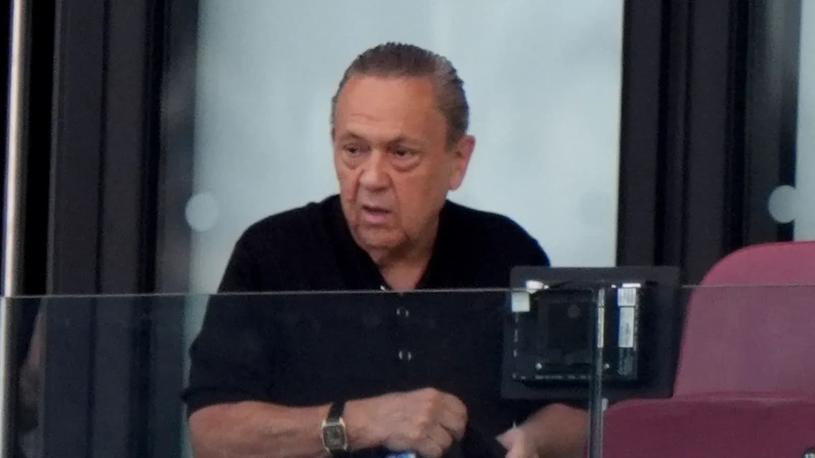 Person observing from a stadium box during event Person observing from a stadium box during event
