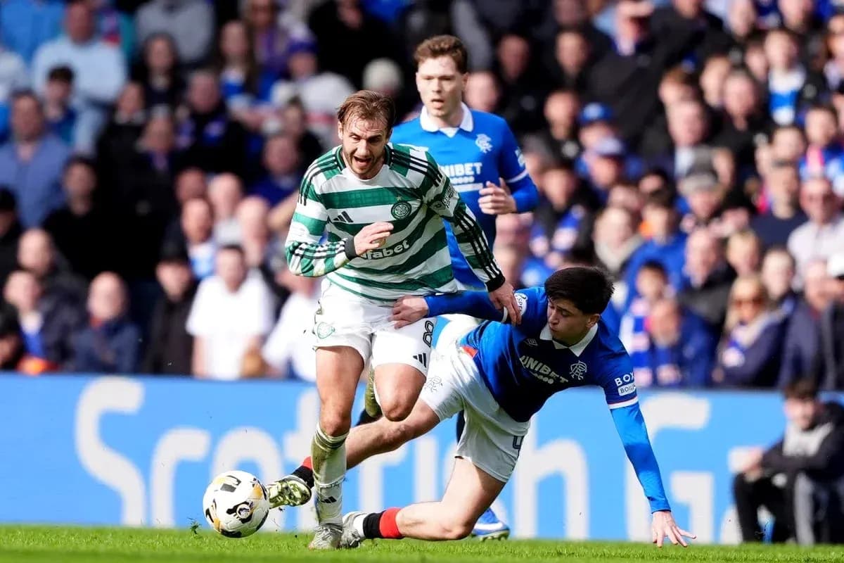 Celtic player evading tackle from Rangers opponent Celtic player evading tackle from Rangers opponent