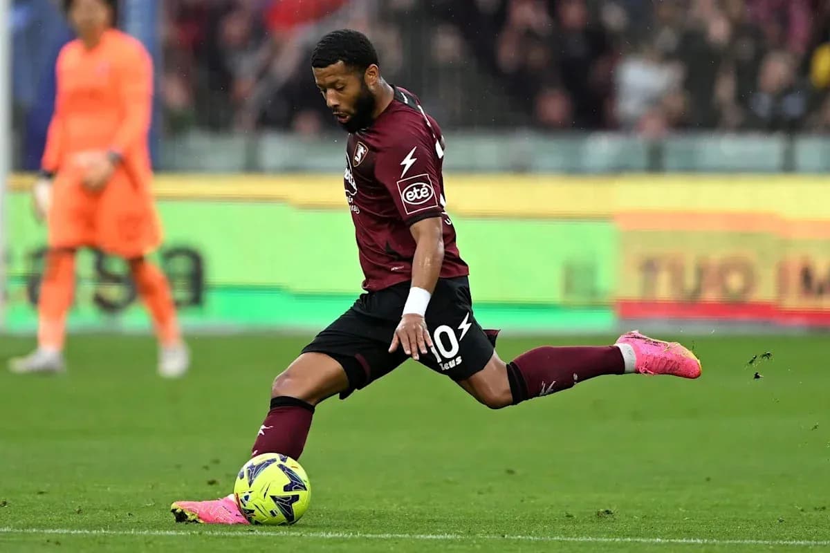 Player kicking the ball during a match Player kicking the ball during a match