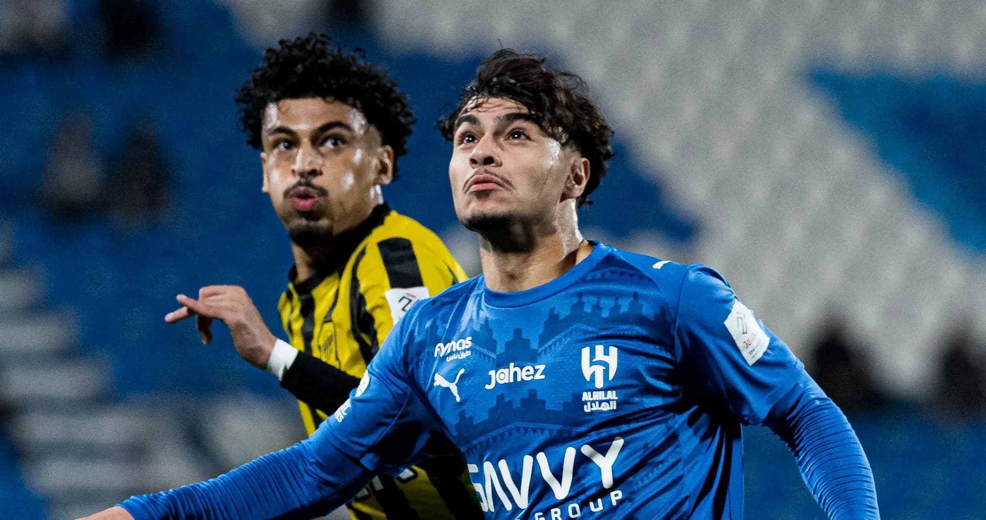 Two players in action during a football match Two players in action during a football match
