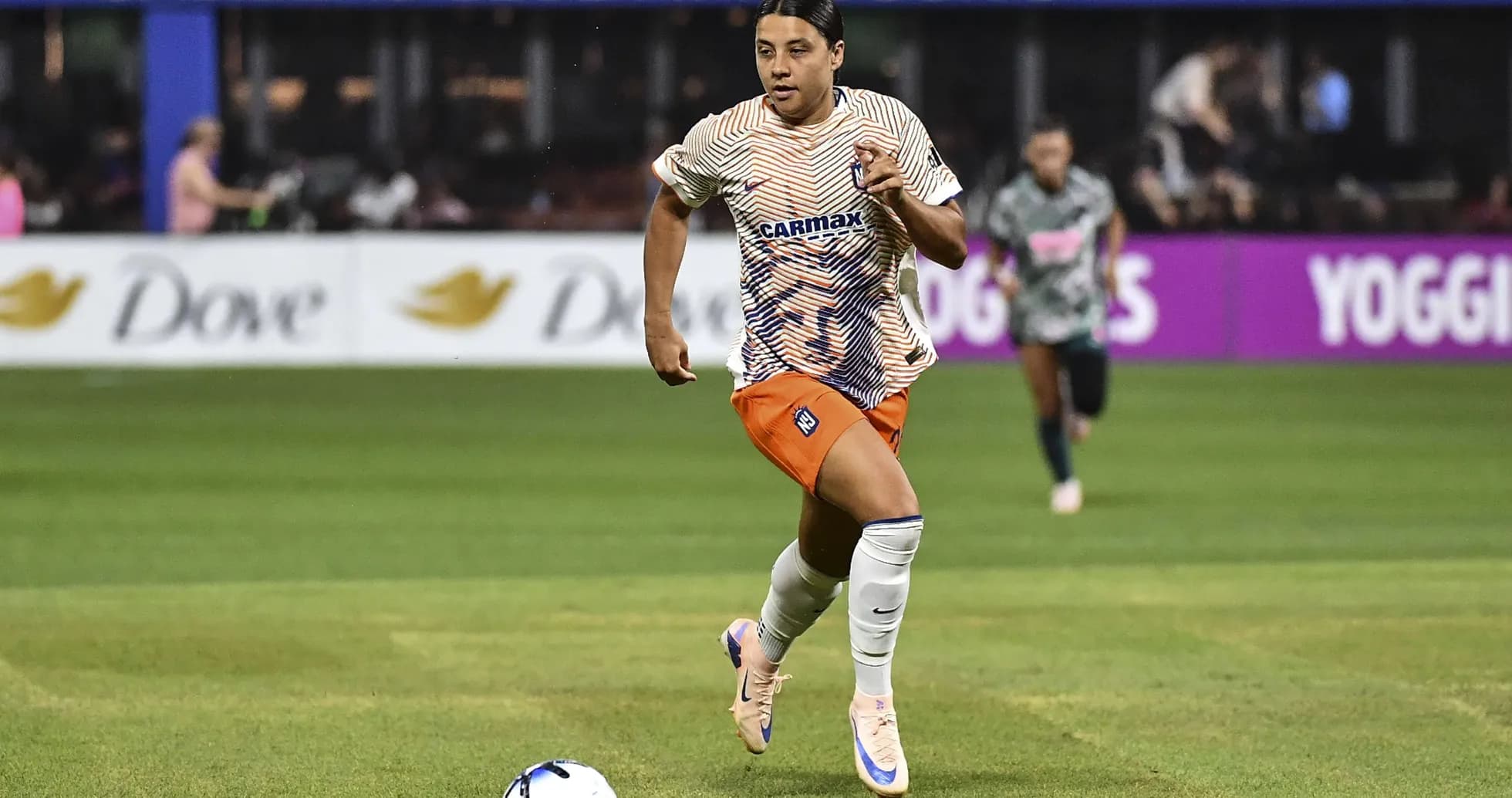 Player running with ball during soccer match Player running with ball during soccer match