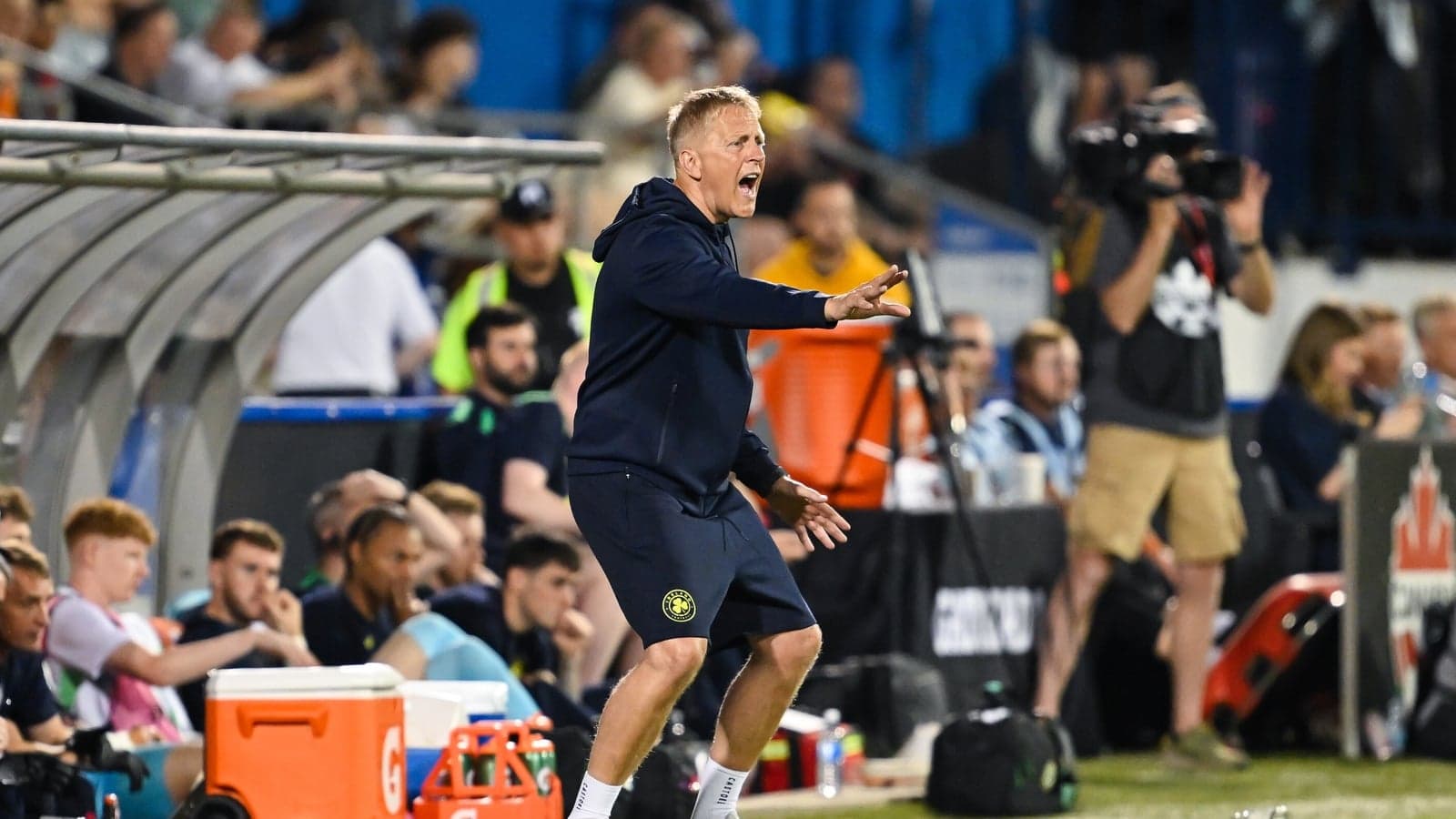 Coach gesturing passionately from the sidelines Coach gesturing passionately from the sidelines