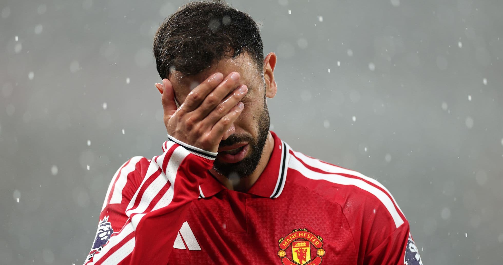 Player in Manchester United kit covering face with hand Player in Manchester United kit covering face with hand