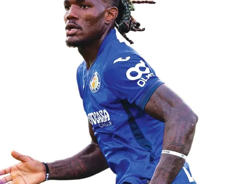 Player celebrating during a match in blue jersey Player celebrating during a match in blue jersey