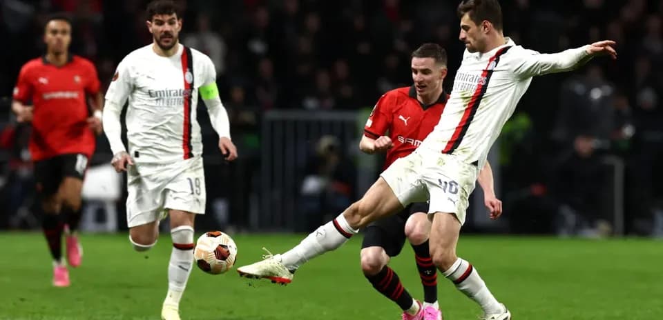AC Milan player challenging for the ball AC Milan player challenging for the ball